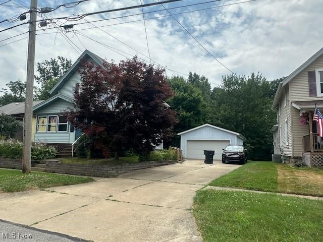 195 Water St, Wadsworth, OH 44281 - view of side of home with a garage, an outdoor structure, and a yard