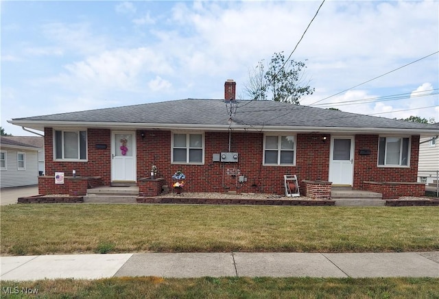 594-596 Hillman Rd, Akron, OH 44312 - view of front of house with brick siding, a chimney, a front lawn, and a shingled roof