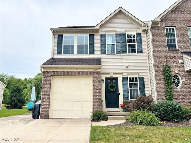 1314 Wellingshire Cir, Cuyahoga Falls, OH 44221 - view of front facade with concrete driveway, a garage, and brick siding