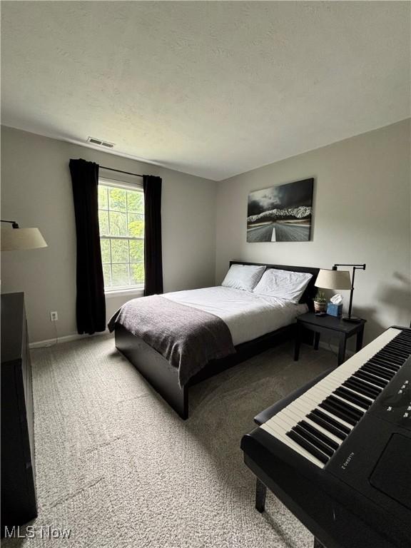 1314 Wellingshire Cir, Cuyahoga Falls, OH 44221 - carpeted bedroom with baseboards and a textured ceiling