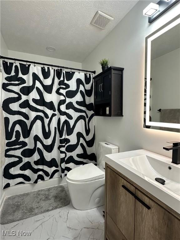 1314 Wellingshire Cir, Cuyahoga Falls, OH 44221 - bathroom with vanity, marble finish floors, a textured ceiling, and curtained shower
