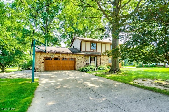 10154 Carlswood Ave NE, Hartville, OH 44632 - tudor home featuring an attached garage, concrete driveway, a front yard, and brick siding