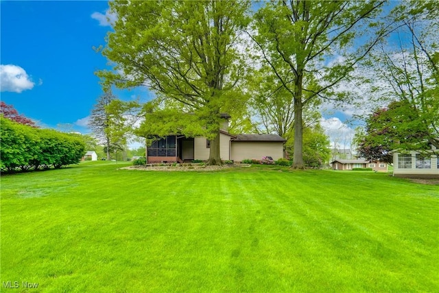 10154 Carlswood Ave NE, Hartville, OH 44632 - view of grassy yard featuring a sunroom