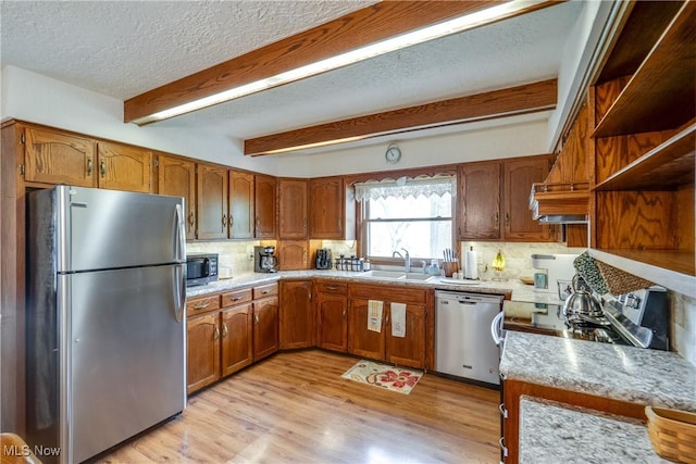 10154 Carlswood Ave NE, Hartville, OH 44632 - kitchen featuring stainless steel appliances, backsplash, a textured ceiling, brown cabinets, and open shelves