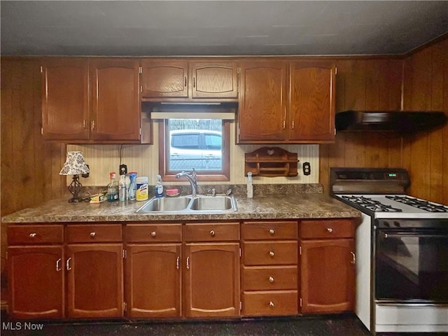 507 Harker Ave, Newell, WV 26050 - kitchen with range with gas cooktop, extractor fan, brown cabinets, and wooden walls