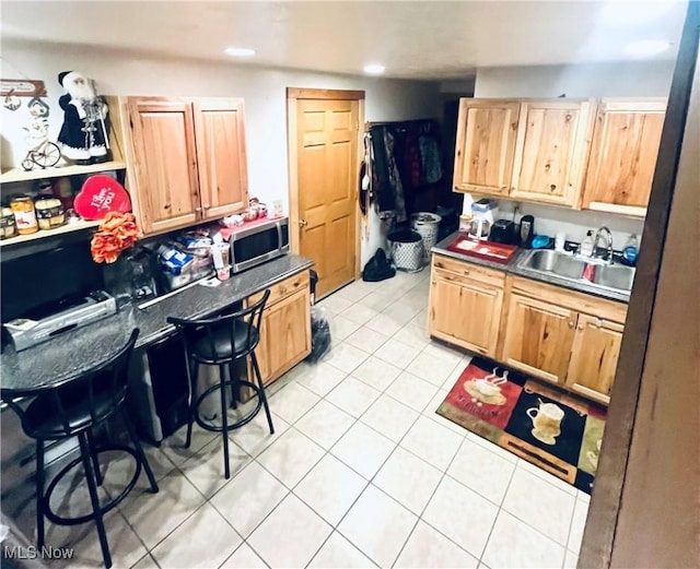617 Valley St, Minerva, OH 44657 - kitchen featuring light tile patterned floors, stainless steel microwave, light brown cabinets, and recessed lighting