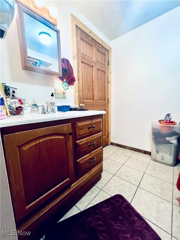 617 Valley St, Minerva, OH 44657 - bathroom with vanity, tile patterned floors, and a textured ceiling