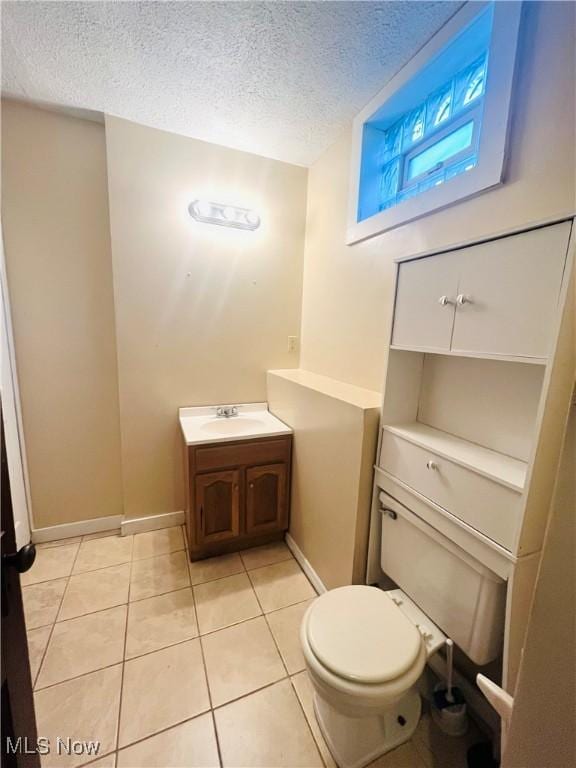 617 Valley St, Minerva, OH 44657 - half bath featuring tile patterned floors, vanity, and a textured ceiling