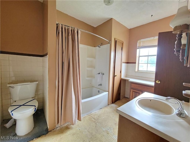 1707 23rd St, Parkersburg, WV 26101 - bathroom featuring tile walls, wainscoting, shower / tub combo with curtain, and vanity