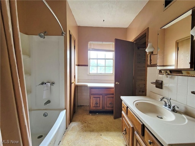 1707 23rd St, Parkersburg, WV 26101 - full bathroom with vanity, shower / bathtub combination with curtain, tile walls, a textured ceiling, and decorative backsplash