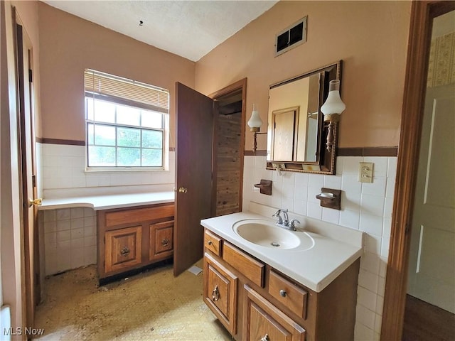 1707 23rd St, Parkersburg, WV 26101 - bathroom featuring tile walls, vanity, and wainscoting