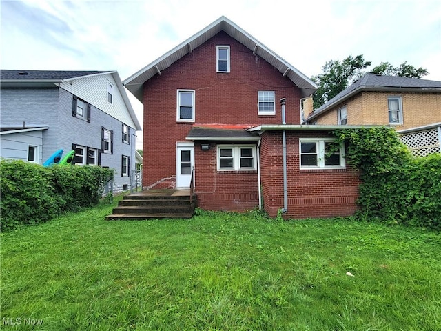 1707 23rd St, Parkersburg, WV 26101 - rear view of property featuring brick siding and a yard