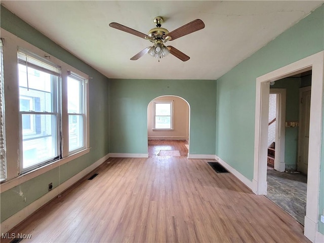 1707 23rd St, Parkersburg, WV 26101 - empty room featuring arched walkways, wood finished floors, and ceiling fan