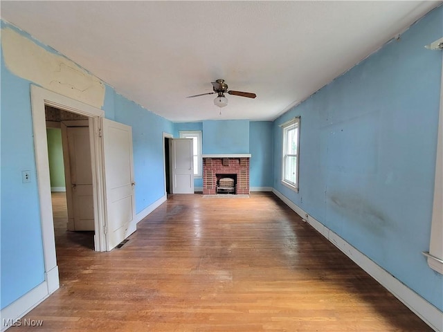 1707 23rd St, Parkersburg, WV 26101 - unfurnished living room featuring a ceiling fan, light wood-style flooring, and a fireplace