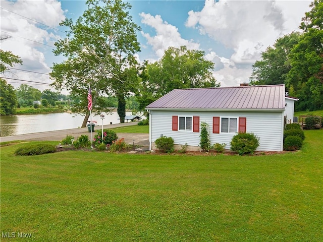 355 Muskingum River Rd, Marietta, OH 45750 - view of front of home featuring a metal roof, a front lawn, a water view, and driveway