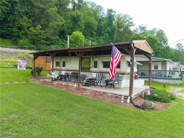 355 Muskingum River Rd, Marietta, OH 45750 - rear view of house with a yard, a patio area, and a storage unit