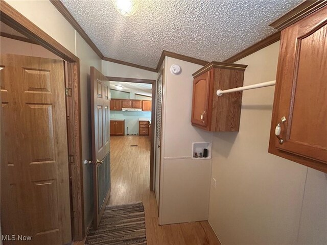 355 Muskingum River Rd, Marietta, OH 45750 - laundry room featuring cabinet space, crown molding, hookup for a washing machine, wood finished floors, and a textured ceiling