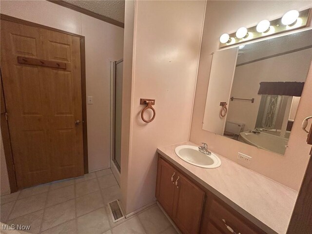 355 Muskingum River Rd, Marietta, OH 45750 - bathroom featuring vanity, a shower stall, tile patterned flooring, and a textured ceiling