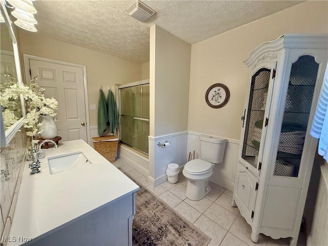 153 Lowes Dr, New Cumberland, WV 26047 - bathroom featuring a shower stall, vanity, wainscoting, a textured ceiling, and tile patterned floors
