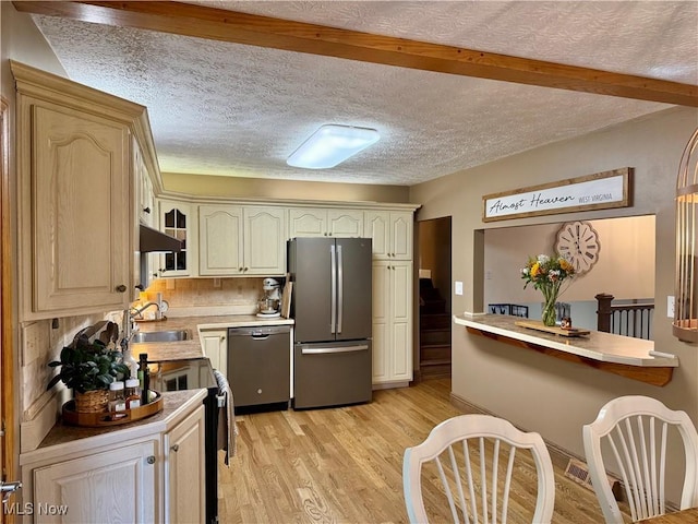 153 Lowes Dr, New Cumberland, WV 26047 - kitchen featuring stainless steel appliances, light wood-type flooring, light countertops, a textured ceiling, and under cabinet range hood