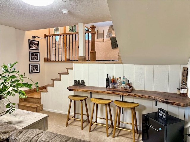 153 Lowes Dr, New Cumberland, WV 26047 - bar featuring a textured ceiling, stairs, and light carpet