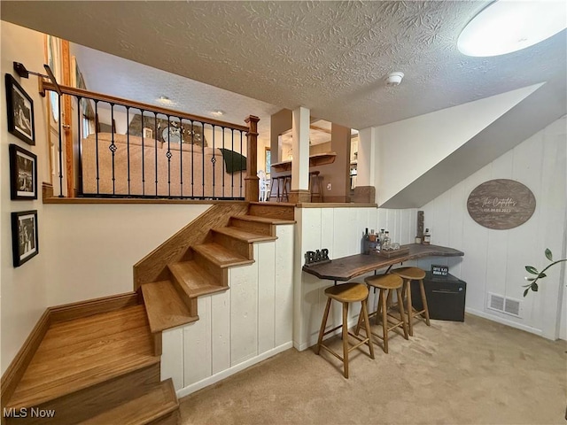 153 Lowes Dr, New Cumberland, WV 26047 - staircase featuring a textured ceiling and carpet flooring