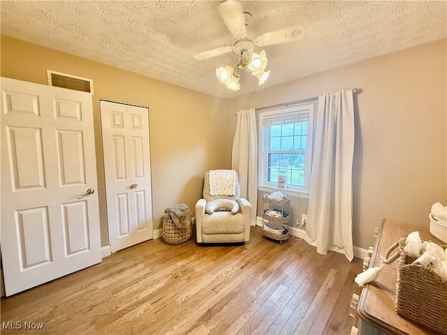 153 Lowes Dr, New Cumberland, WV 26047 - living area featuring hardwood / wood-style flooring, a textured ceiling, and ceiling fan