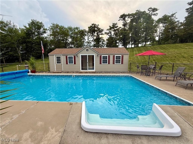 153 Lowes Dr, New Cumberland, WV 26047 - view of swimming pool featuring an exterior structure, an outdoor structure, a patio area, and view of wooded area