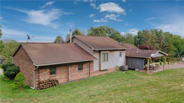 153 Lowes Dr, New Cumberland, WV 26047 - rear view of house featuring a patio, a yard, brick siding, and roof with shingles