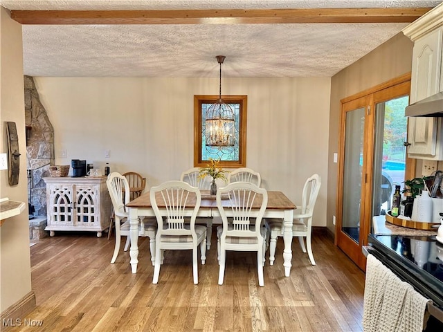153 Lowes Dr, New Cumberland, WV 26047 - dining area with light wood-style floors, a chandelier, and a textured ceiling