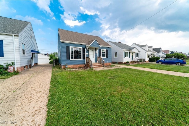 8006 Chesterfield Ave, Parma, OH 44129 - bungalow-style home with an outbuilding, a front lawn, a residential view, and a garage