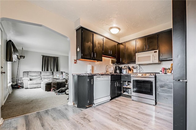 8006 Chesterfield Ave, Parma, OH 44129 - kitchen with stainless steel appliances, light wood-type flooring, open floor plan, dark brown cabinets, and crown molding