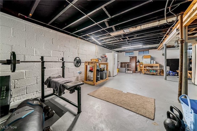 8006 Chesterfield Ave, Parma, OH 44129 - unfinished basement featuring freestanding refrigerator and concrete block wall