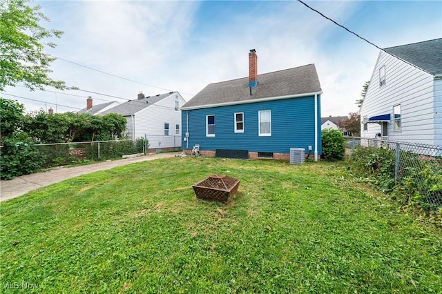 8006 Chesterfield Ave, Parma, OH 44129 - rear view of house with a chimney, a fenced backyard, and an outdoor fire pit