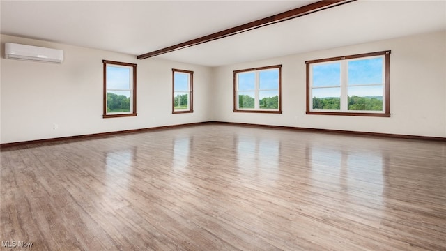 52110 Spencer Rd, Cumberland, OH 43732 - spare room featuring wood finished floors, plenty of natural light, beamed ceiling, and a wall mounted AC
