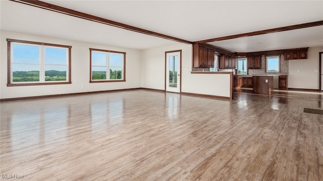 52110 Spencer Rd, Cumberland, OH 43732 - unfurnished living room with beamed ceiling, wood finished floors, and plenty of natural light