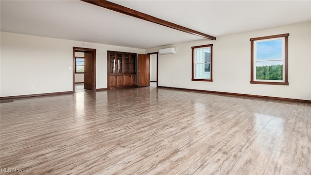 52110 Spencer Rd, Cumberland, OH 43732 - unfurnished room with wood finished floors, beamed ceiling, and a wall mounted air conditioner