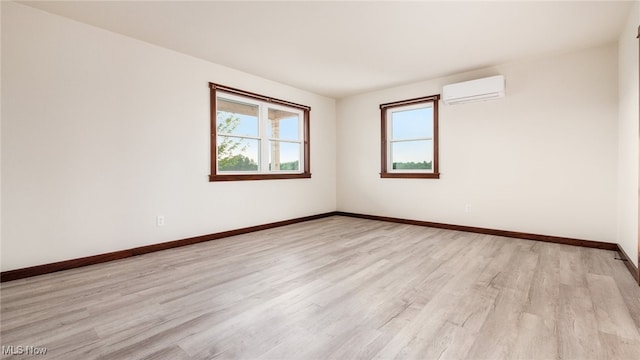 52110 Spencer Rd, Cumberland, OH 43732 - empty room with light wood-type flooring and an AC wall unit
