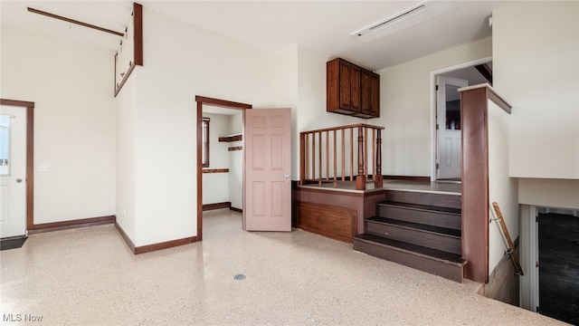 52110 Spencer Rd, Cumberland, OH 43732 - stairway featuring speckle patterned floor and baseboards
