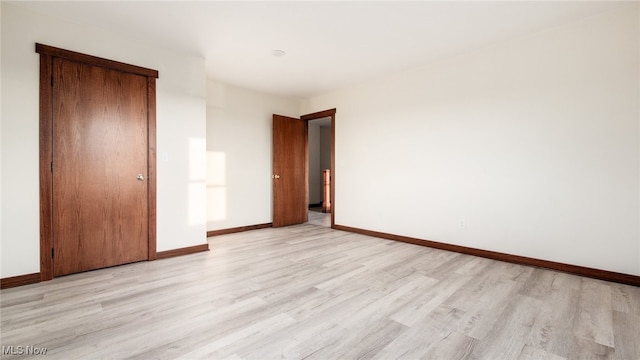 52110 Spencer Rd, Cumberland, OH 43732 - unfurnished bedroom with light wood-type flooring and baseboards