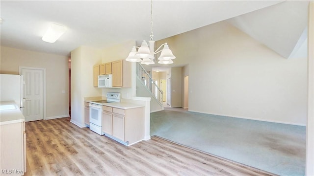 8531 Creekside Dr, Sagamore Hills, OH 44067 - kitchen featuring a chandelier, white appliances, light countertops, hanging light fixtures, and light brown cabinetry