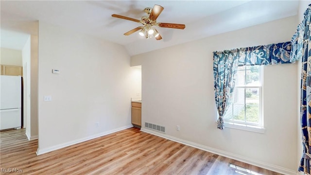 8531 Creekside Dr, Sagamore Hills, OH 44067 - unfurnished bedroom featuring freestanding refrigerator, light wood finished floors, lofted ceiling, and ceiling fan