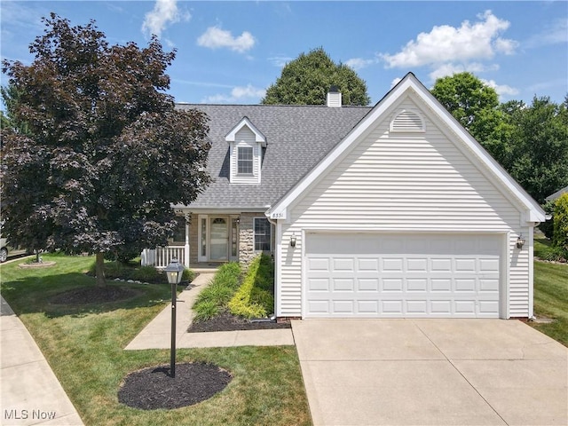 8531 Creekside Dr, Sagamore Hills, OH 44067 - view of front of property featuring a front lawn, a shingled roof, concrete driveway, and a chimney