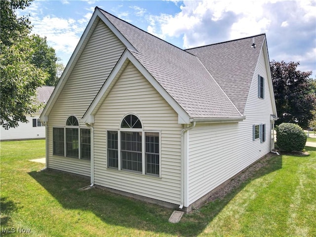 8531 Creekside Dr, Sagamore Hills, OH 44067 - view of property exterior featuring roof with shingles and a lawn