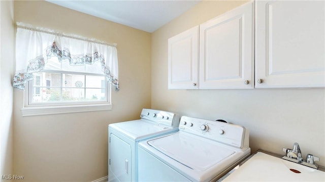 8531 Creekside Dr, Sagamore Hills, OH 44067 - laundry area with cabinet space and washing machine and dryer