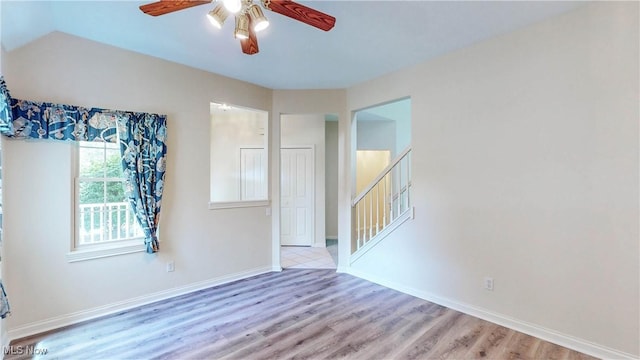 8531 Creekside Dr, Sagamore Hills, OH 44067 - empty room with a ceiling fan, wood finished floors, stairs, and lofted ceiling