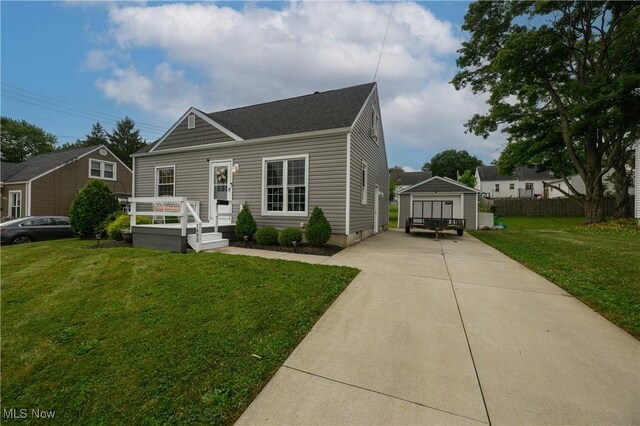 1492 Ries St, Barberton, OH 44203 - view of front of house with a front lawn, an outbuilding, a shingled roof, crawl space, and driveway