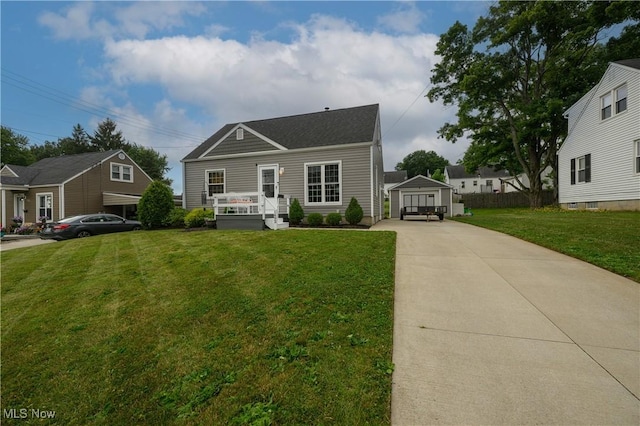 1492 Ries St, Barberton, OH 44203 - view of front facade with an outbuilding, concrete driveway, a front yard, and a detached garage