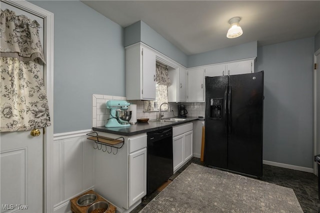 1492 Ries St, Barberton, OH 44203 - kitchen featuring black appliances, dark countertops, white cabinets, backsplash, and a wainscoted wall