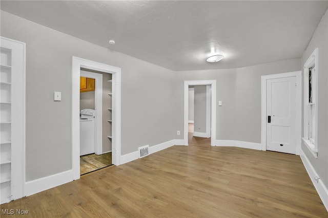 523 Gage St, Akron, OH 44311 - unfurnished bedroom with light wood-style floors, a walk in closet, and washer / dryer